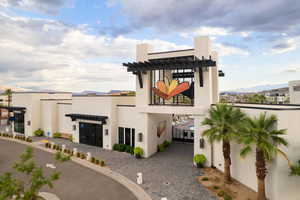 View of front facade featuring stucco siding, a mountain view, and a patio
