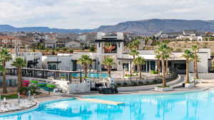 Community pool featuring a mountain view, a residential view, and a patio area