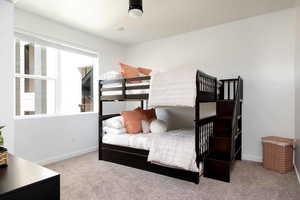 Bedroom featuring carpet floors and baseboards