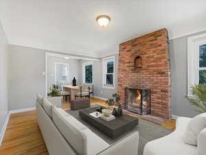 Living area featuring light wood-style flooring and a fireplace