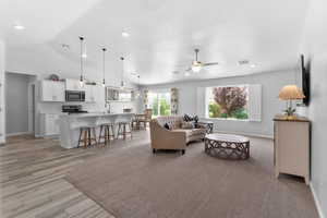 Living room/Great room featuring ceiling fan, tile flooring, vaulted ceiling, and recessed lighting