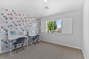 Bedroom 2 with carpet flooring and a wallpapered accent wall
