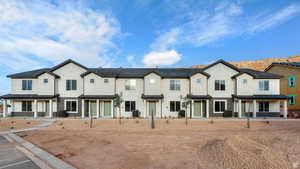 Multi unit property with covered porch and stucco siding