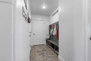 Mudroom with light wood-type flooring and baseboards