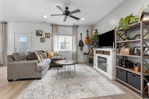 Living area with wood finished floors, a ceiling fan, and recessed lighting