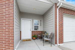 Property entrance featuring brick siding