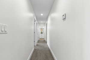 Corridor with carpet floors and recessed lighting