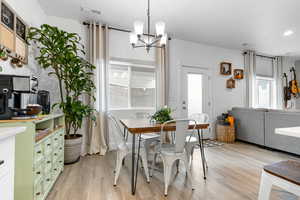 Dining room with a chandelier, light wood-style floors, and recessed lighting