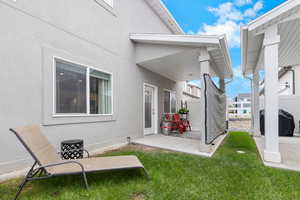 Rear view of house featuring a patio and stucco siding