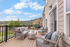 Wooden deck featuring an outdoor hangout area and a mountain view
