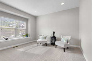 Sitting room with carpet floors and recessed lighting