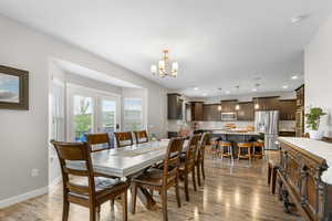 Dining space with a chandelier, light wood finished floors, and recessed lighting