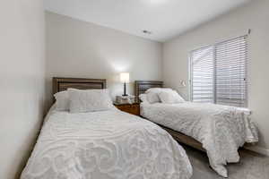 Bedroom featuring baseboards and carpet flooring