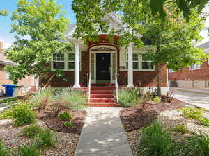 View of front of house with brick siding and covered porch