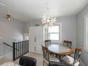 Dining room featuring a chandelier, light tile patterned floors, and a textured ceiling
