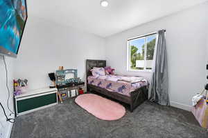 Carpeted bedroom featuring baseboards