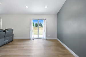 Empty room with light wood-type flooring and recessed lighting