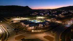 Aerial view at dusk of a mountain view and view of pool