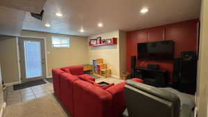 Family room with recessed lighting, light tile patterned floors, and a textured ceiling