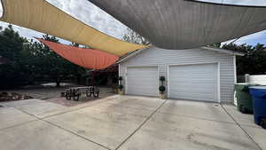 Garage featuring concrete driveway