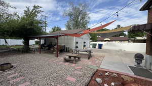 Fenced backyard with a patio area and and garage