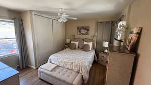 Bedroom featuring wood finished floors, a closet, and ceiling fan