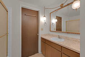 Bathroom featuring vanity and a shower