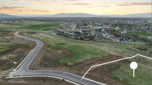 Aerial view at dusk of a mountain view and property parcel outlined