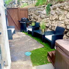 View of side fenced yard.  The stairs from the lower unit lead to this area.