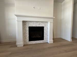Detailed view of wood finished floors and a tile fireplace