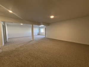 Carpeted spare room featuring baseboards and recessed lighting