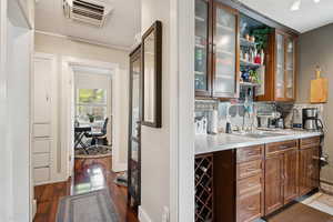Hallway with view of kitchen, bedroom, and built in storage