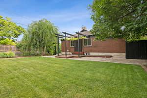 Fenced backyard featuring a pergola and a patio area