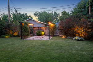 Yard at dusk with a patio area