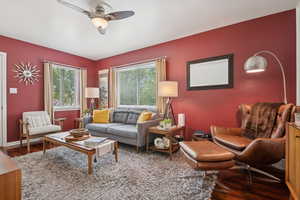 Living room with wood finished floors and a ceiling fan