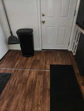 Detailed view of vinyl kitchen flooring and basement access