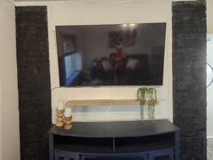 Stacked black rock and shiplap TV wall