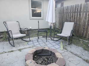 View of patio with an outdoor fire pit