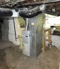 Basement with furnace, original rock foundation, work bench, and cold storage sleeving