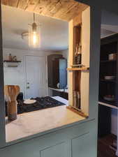 Pass-through opening to kitchen featuring custom built-in condiment holders