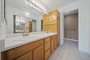 Bathroom featuring tile patterned flooring and double vanity