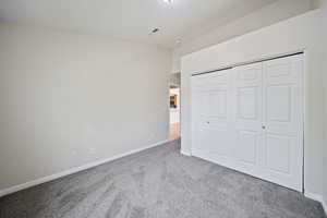 Unfurnished bedroom with carpet floors and a closet