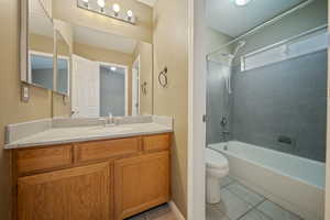 Bathroom featuring tile patterned floors, shower / tub combination, and vanity