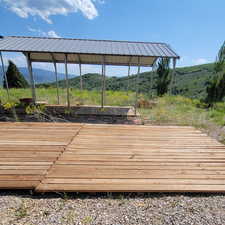 Wooden terrace featuring a mountain view
