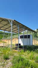 View of car parking featuring a storage unit