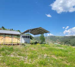 View of yard with a detached carport and a mountain view