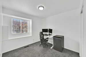 Carpeted office with baseboards