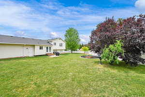 View of yard featuring an outdoor fire pit, french doors, and entry steps