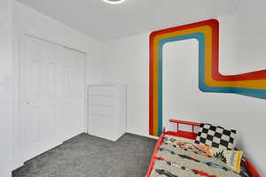 Carpeted bedroom featuring baseboards