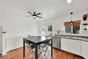 Kitchen with dishwasher, white cabinetry, ceiling fan, and light wood-style flooring